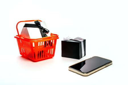 Online shopping concept - Shopping Cart, tablet pc or smartphone, gift box isolated on white background. Copy space for text. Black fridayの写真素材