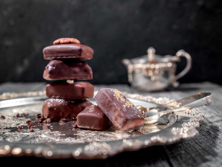 Dark handmade chocolate stack with cacao chips and nutsの写真素材