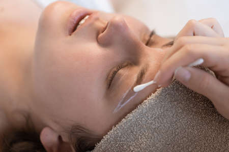 Coloring the eyebrows and eyelashes with henna in a beauty salon.の写真素材