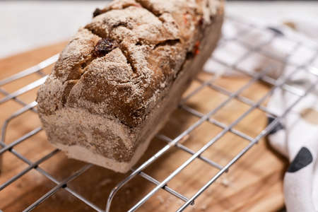 Sourdough homemade fruit bread on baking grid.の写真素材