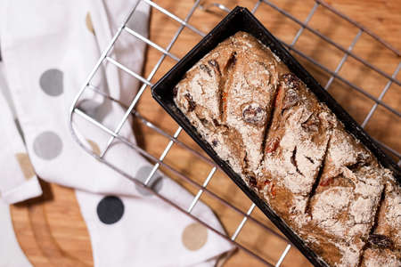 Sourdough homemade fruit bread on baking grid.
