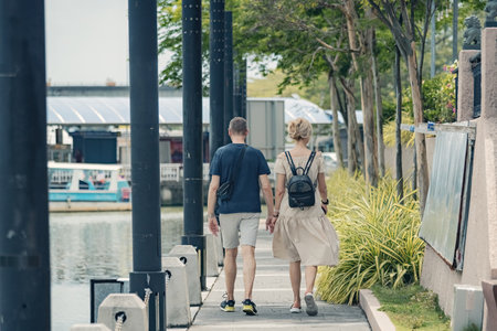 Couple back view walking along the streetの写真素材