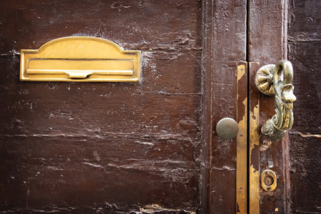 Antique bronze door knocker in the old house in Italyの写真素材