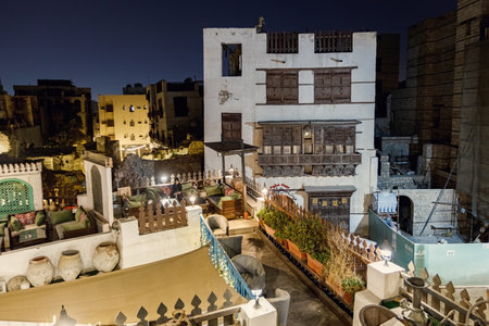 Historical house in the old town of Jeddad with wooden windows and doors at evening lights Saudi Arabiaのeditorial素材