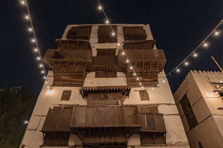 Historical house in the old town of Jeddad with wooden windows and doors at evening lights Saudi Arabiaのeditorial素材