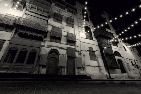 Historical house in the old town of Jeddad with wooden windows and doors at evening lights Saudi Arabiaのeditorial素材