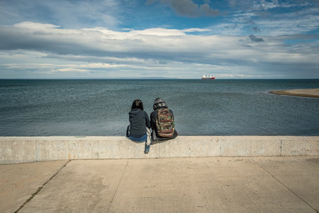 Punta Arenas Chile seaside Patagonia Chilena Chile. Couple date looking at the seaの写真素材