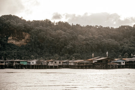 Fishing village houses over the water garbage poor areas in Sabah province in Malaysiaのeditorial素材