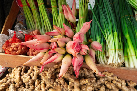 Fresh vegetables: green onion and ginger flowers on the market counter in Malaysia