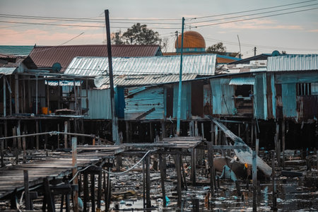 Fishing village houses over the water garbage poor areas in Sabah province in Malaysiaのeditorial素材