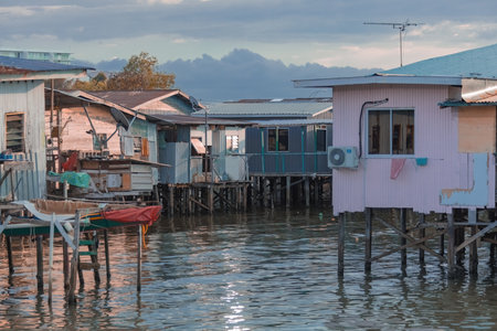 Fishing village houses over the water garbage poor areas in Sabah province in Malaysia