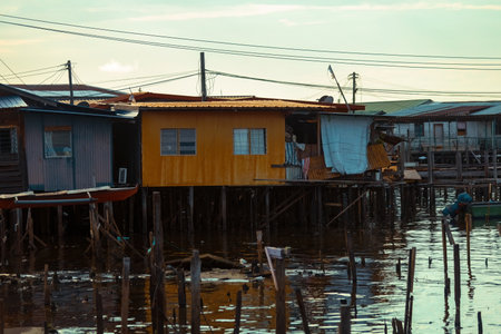 Fishing village houses over the water garbage poor areas in Sabah province in Malaysiaのeditorial素材