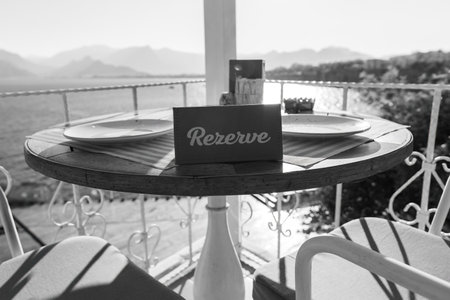 Reserve sign on the table red color sunny terrace cafe flowers decoratedの写真素材