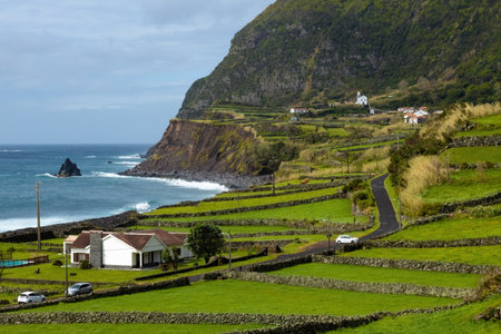 Breathtaking view of the houses on the cliff at Atlantic ocean coast in Azores islands Portugalの写真素材