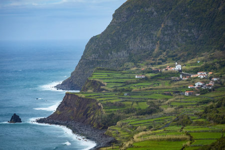 Breathtaking view of the houses on the cliff at Atlantic ocean coast in Azores islands Portugalの写真素材