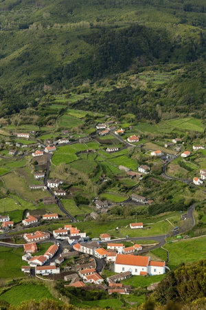 Breathtaking view of the houses on the cliff at Atlantic ocean coast in Azores islands Portugalの写真素材