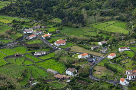 Breathtaking view of the houses on the cliff at Atlantic ocean coast in Azores islands Portugalの写真素材
