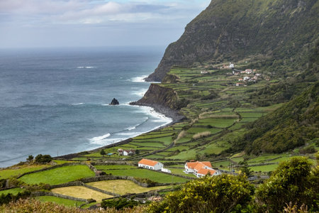 Breathtaking view of the houses on the cliff at Atlantic ocean coast in Azores islands Portugalの写真素材