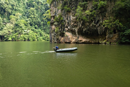 Limestone mountains scenery Mirror lake with small boat in Perak province of Malaysiaの写真素材