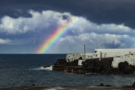 Rainbow over the sea on stormy day Atlantic Ocean Azores islandsの写真素材