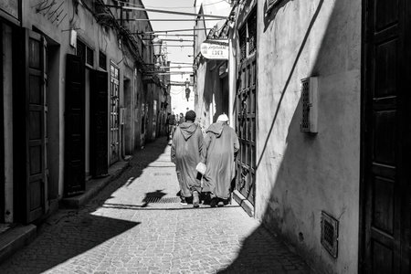 Old town Medina in Marakkesh narrow street local people at daily life Morocco