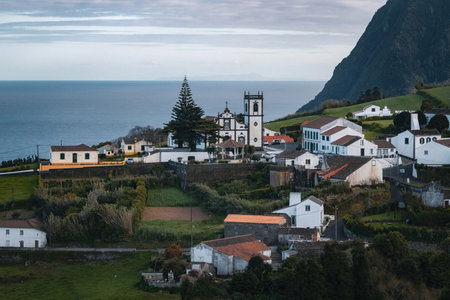Green hills and traditional white houses in Azores islands Portugalの写真素材