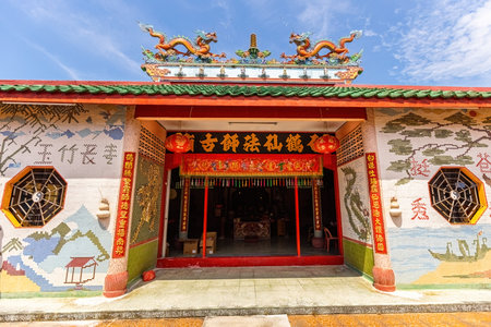Traditional Chinese temple with green-tiled roof and ornate red pillars in Pulau Ketam, Malaysiaのeditorial素材