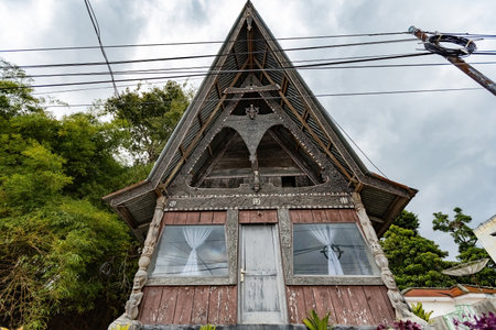 Traditional Toba batak houses with pointed roofs at Samosir island at Toba lake North Sumatra Indonesiaのeditorial素材