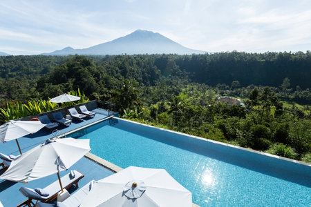 Swimming pool and sunbeds at luxury resort in Bali with volcano view Indonesiaのeditorial素材