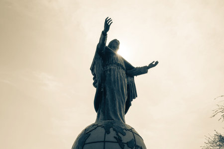 Statue of Cristo Rei of Dili against the sun rays in Timor Leste