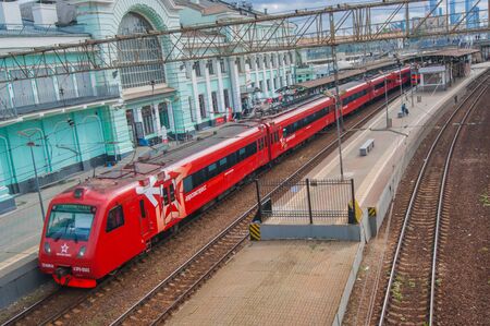 Moscow, Russia - July 2019. Aeroexpress. Railway, ancient architecture, top view from the bridge to the red train. Editorial Photoのeditorial素材