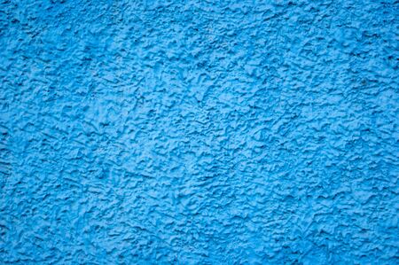 Texture of concrete wall with decorative plaster - photo. Color is blue. Granularity, roughness. Facade. Background.の写真素材