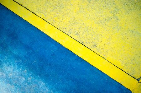 Background, texture - concrete wall, blue and yellow. Rough surface.