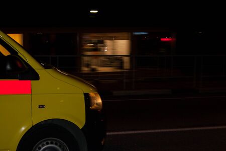 Movement. The nose of the yellow car in the background of the city. The background is in disfocus. A car.の写真素材