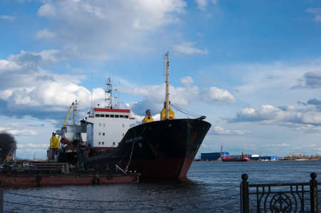 Russia, Arkhangelsk - May 2020. Arkhangelsk sea trade port, a major Russian northern port. Embankment, pier. Spring River and blue sky with white cloudsのeditorial素材