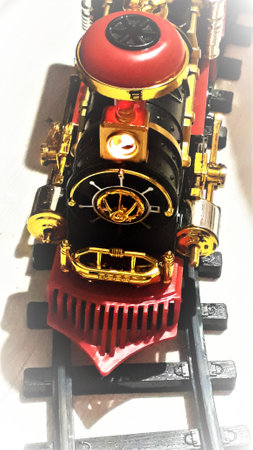 Childrens railway - locomotive stands on black rails against the background of white laminate. View...