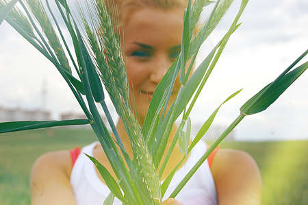 Beautiful curly girl posing on the fieldの写真素材