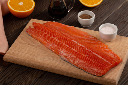 Fresh trout fillet on a cutting board, preparation for cookingの写真素材