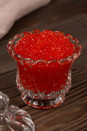 Red caviar in a beautiful transparent glass jarの写真素材
