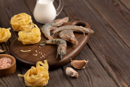Dry fettuccine, fresh raw shrimp, garlic and cream, pasta recipe, open spaceの写真素材