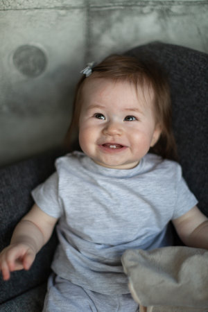 Little baby girl laughs, a smile of two teeth