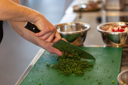 Cook's hands chop finely fresh dillの写真素材