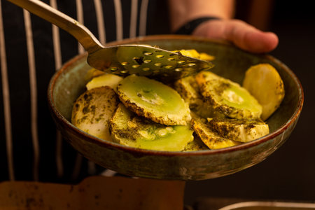 Baked crookneck with herbs and pesto sauceの写真素材