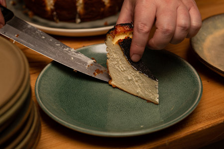 The cook puts a piece of cottage cheese pie on a plate