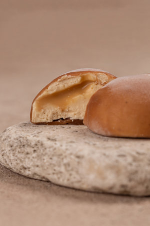 Traditional Japanese dessert, mochi cake in thin rice dough with caramel filling, cut