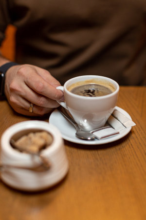 Close-up of an espresso cup in a man's handの写真素材
