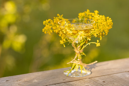 A glass of wine decorated with wildflowers, a place for textの写真素材