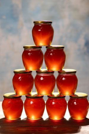 Jars of fresh flower honey on the tableの写真素材