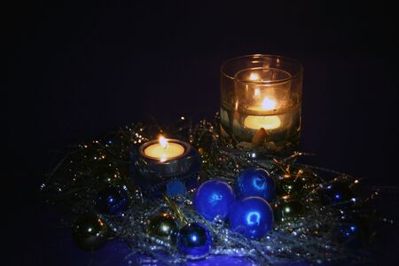 two blue candles burning with Christmas tree toys compositionの写真素材