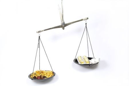 Scales symbolizing Homeopathy is more effective than traditional medicine